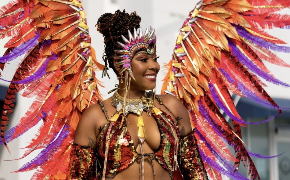 Tracey standing in carnival costume with large wings